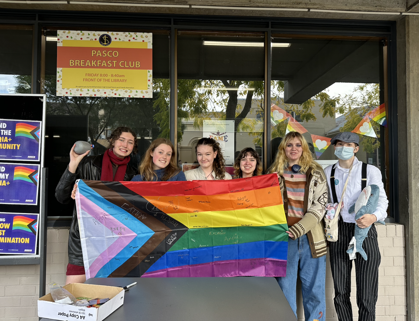 A 5 Pride flag signing