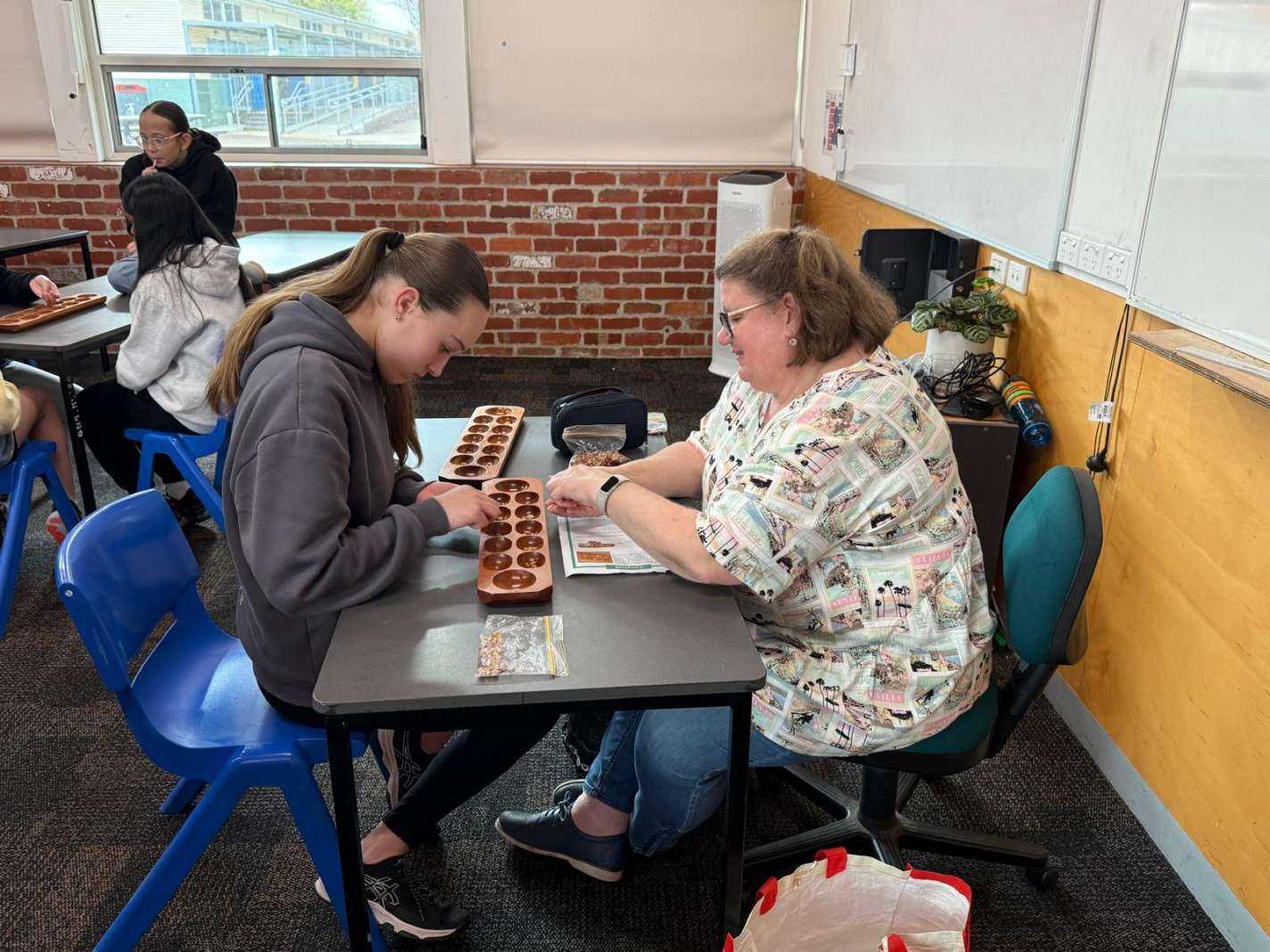 Student playing Congklak